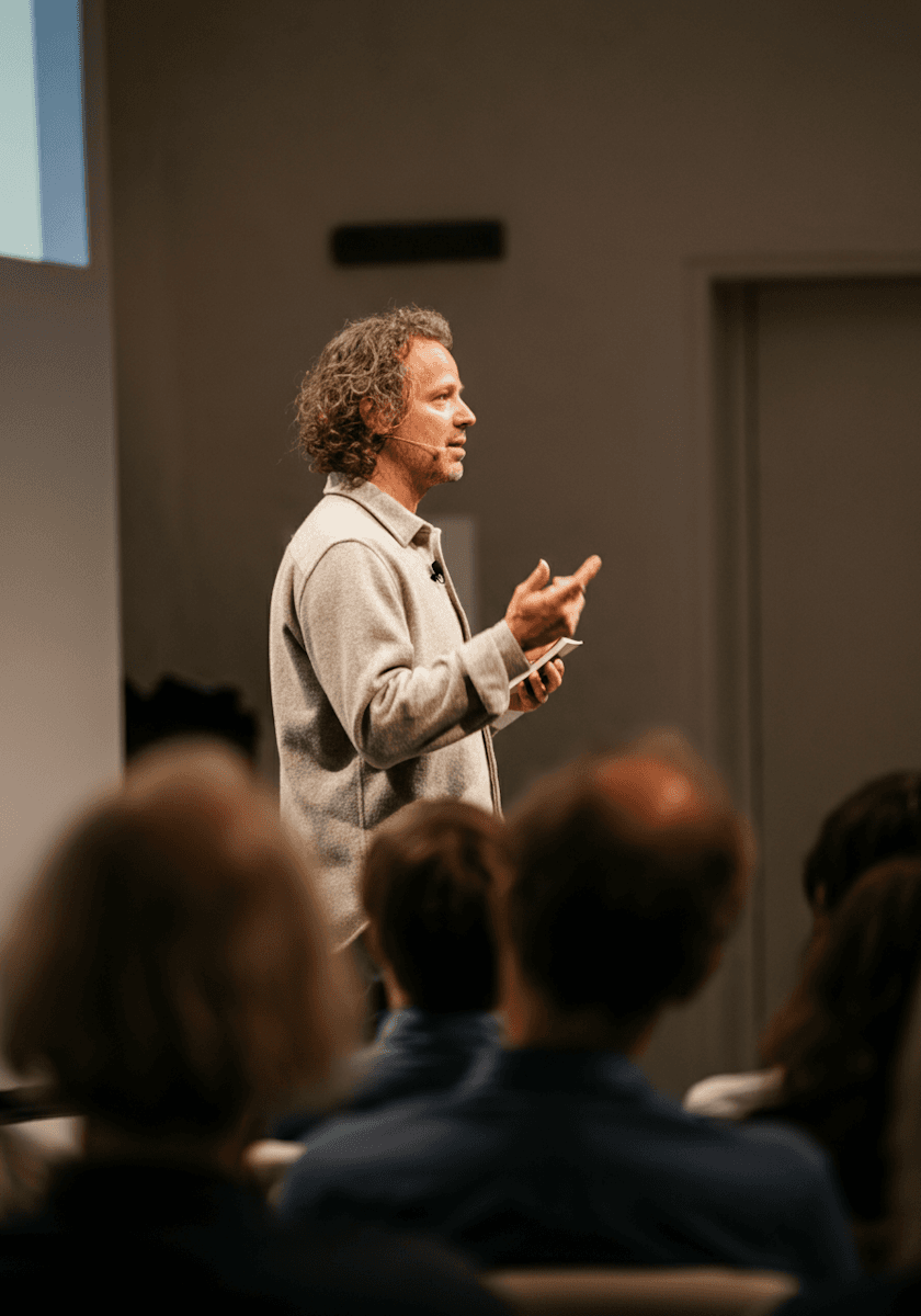 A speaker walking a seated group through a live session